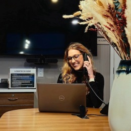 a woman using a phone and a computer