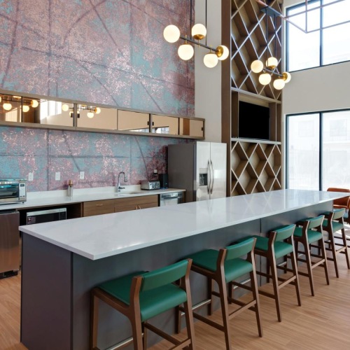 a kitchen with a bar and chairs