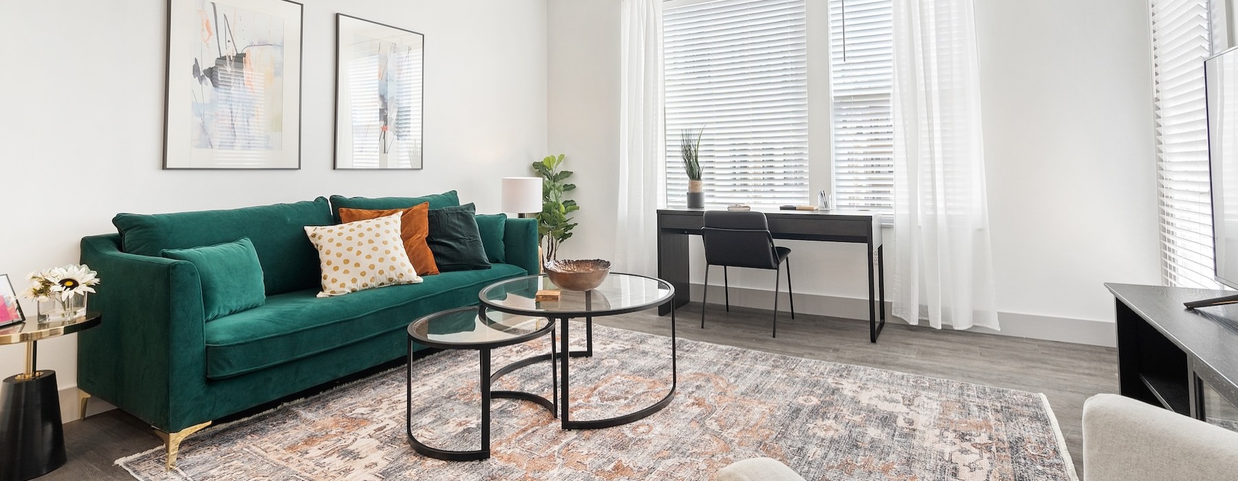 a living room with a green couch and a coffee table