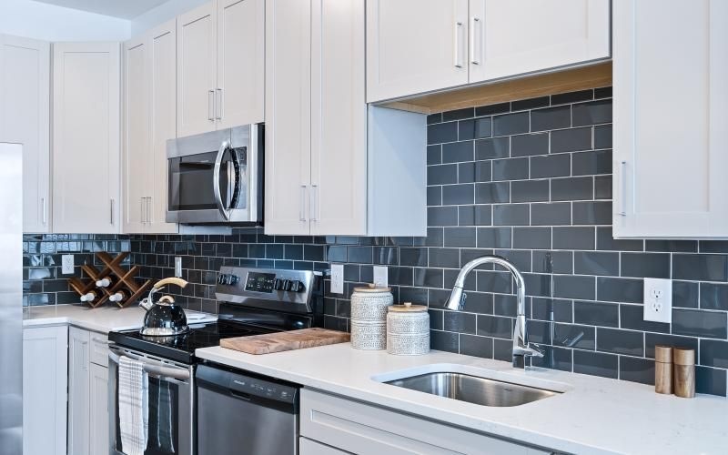 a kitchen with white cabinets