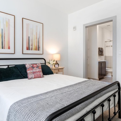 a bedroom with a bed and lamps